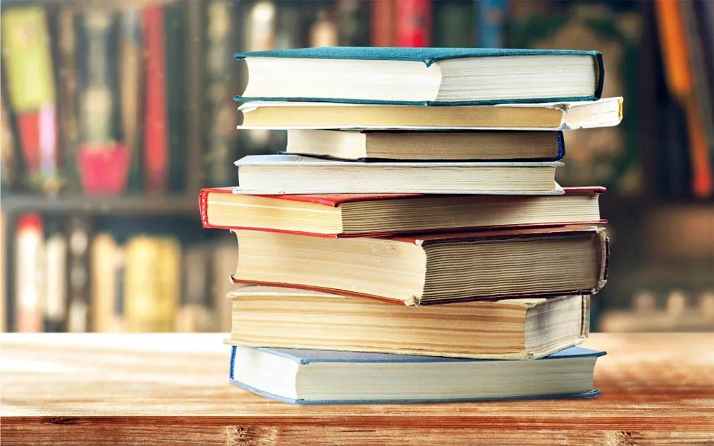 Used college textbooks in good condition on a table